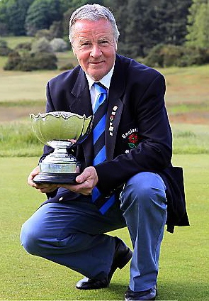 TREBLE TOPS: Oldham member Alan Squires shows off the English Amateur Seniors trophy. Picture courtesy of Tom Ward/England Golf 
