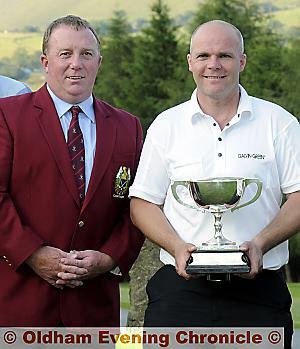 SAME AGAIN, PLEASE: Kris Suttcliffe, pictured receiving the Oldham and District Championship trophy 12 months ago from the then Saddleworth captain John Knight, is out to retain his title on his own course at Crompton and Royton on Sunday. 

The draw for the two-round competition is below. 
