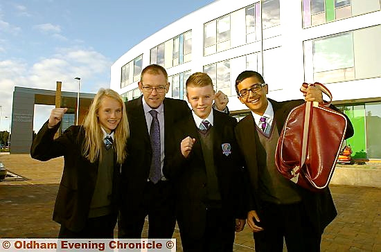 FIRST day: head teacher Mike McGhee is pictured greeting pupils Lydia and Jake Grayson and Siddartha Paul as Newman College opens. 