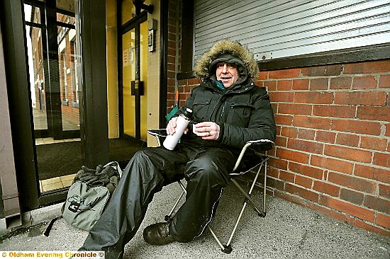 KEEPING WARM . . . First-in-queue Jack Slater from Royton arrived at Boundary Park at 6am today, as Everton tickets went on open sale. 