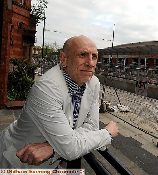 Artist Brian Clarke looks at the changing face of Oldham as he views tramlines in the process of being installed in Union Street 
