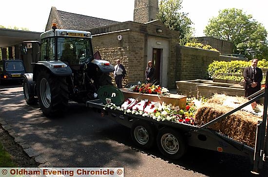 THE tractor and coffin arrives at Hollinwood Crematorium  

