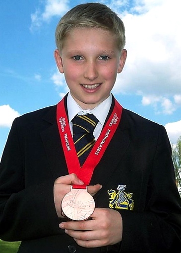 Alfie Astley, showing off his bronze medal from the qualifying gala, won gold in the double mini trampette in Birmingham. 