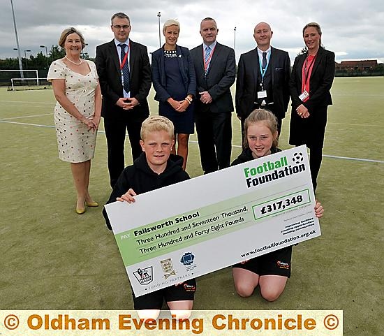 Failsworth School receives £317,348 from Football Foundation to refurbish 2G pitch. Ann Hannaghan (Chair of Governors), Phil Quirk (Deputy Head), Natalie Woodford (FA Football Development Manager), John Meagher (Headteacher), Jim Ryan (Fails School Director of Support Services) and Andrea Atkinson (Deputy Head). 

FRONT are year 7 pupils Jacobe Anderson and Charlotte Garside. 
