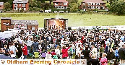 The crowd gather at Delph Cricket Club for the Party in the Park 