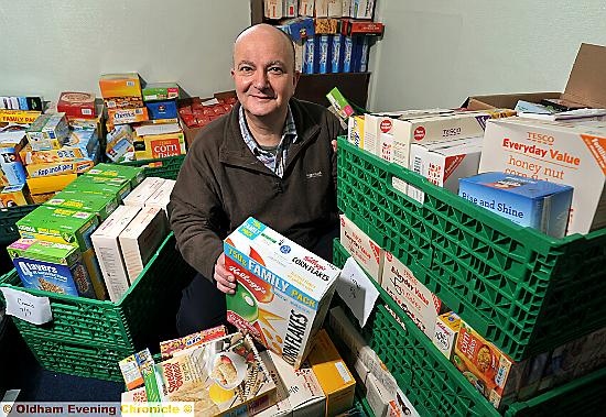 STOCKING up: Oldham Foodbank manager Andrew Barr boxes up donated goods 

