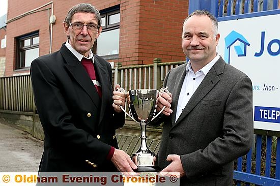 Rugby Oldham chairman Geoff Cooke (left) presents the Challenge trophy to Higginshaw secretary John Mellor. 