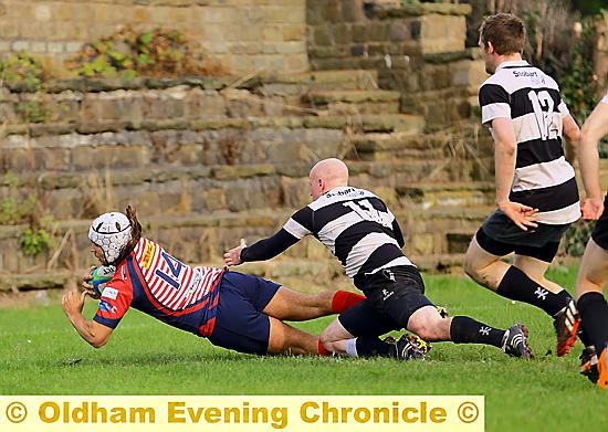 Jason Green plunges over the line for a try.