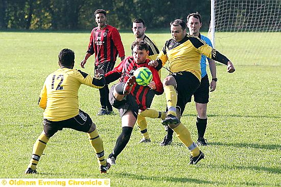 GOING FOR IT: Limeside King George’s Will Buckley (centre) is challenged by two Coppice players.