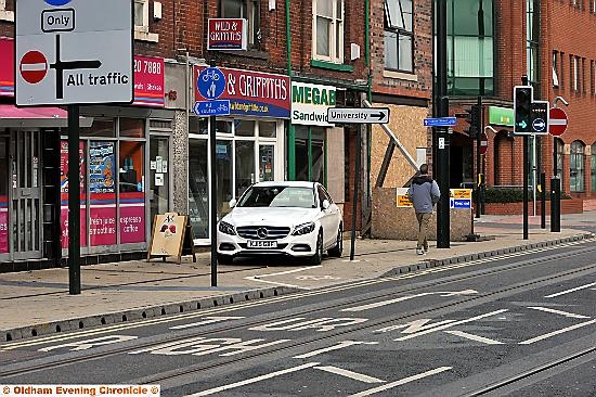 OUT of order . . . a Mercedes driver parks on the pavement