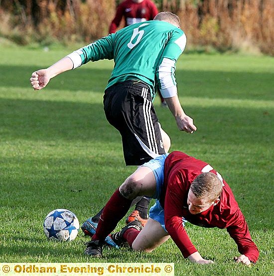 GROUNDED . . . Paul Hinchliffe (left), player-manager of Oldham Hulmeians, challenges for the ball. PICTURE: PAUL STERRITT