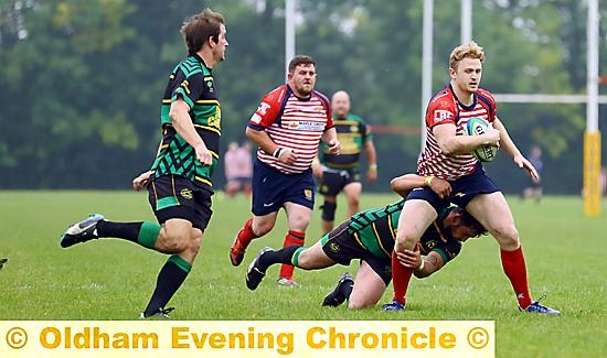 DRIVING FORWARD . . . Charlie Roscoe tries to make ground for Oldham.