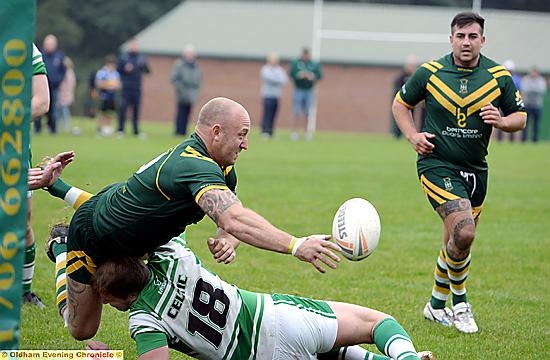 HEADING FOR A FALL . . . Chris Carter (left), of Oldham St Anne’s, attempts to pick out a team-mate.