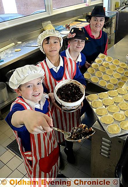 Whitegate End P School, Chadderton. Pupils become teachers. Being cooks are (l-r) Bobby Thompson (9) Jessica So (10)and Oliver Chapman (10) over the watchful eye Cook supervisor Kerry Johnson. 