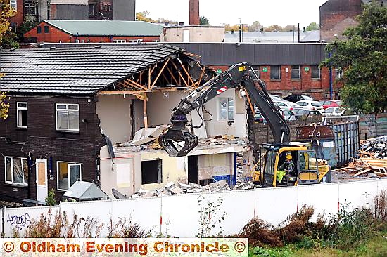 GOING . . . demolition workers get to work on the final RSPCA building on the Rhodes Bank site