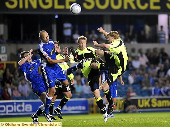 EYES WIDE SHUT . . . Chris Taylor competes for the ball with Lions defenders during Athletic’s 2-0 loss at Millwall back in the 2009-10 season.