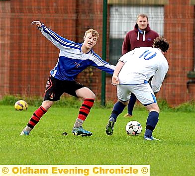 IT’S THAT WAY . . . Oldham XI’s Jamie Clark (left) is challenged.