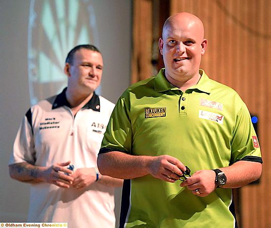 Local player Mark McGeeney (white shirt) enjoyed himself against 2014 PDC world champion Michael van Gerwen,who is seen posing with a fan (top, right).
