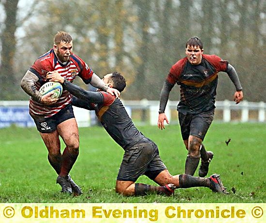 Oldham’s Ryan Jackson shrugs off a tackle.