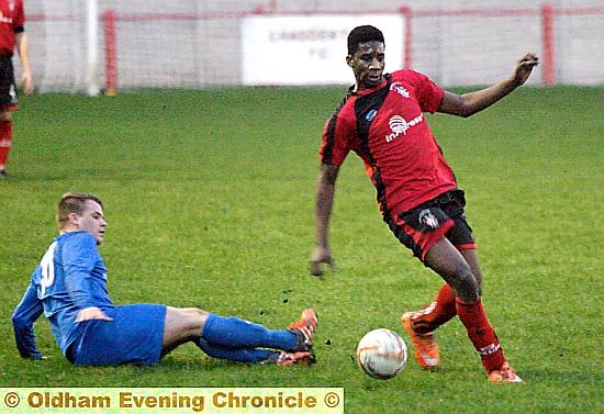 GO FOR IT . . . Chadderton’s Leon Iloube (right) leaves a defender trailing in his wake.