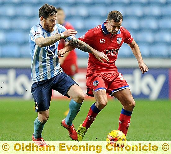 PIVOTAL ROLE . . . Richie Wellens, who operated at the base of the Athletic midfield, fends off a challenge. Pictures by ALAN HOWARTH
