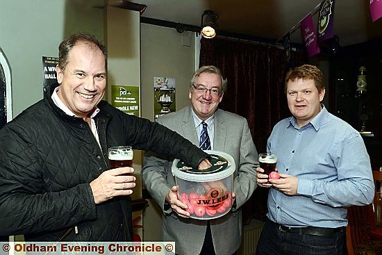 NUMBERS GAME . . . William Lees-Jones, managing director of sponsors JW Lees Brewery, Pennine Cricket League chairman Nigel Tench and vice-chairman Glenn Kershaw, make the draw for the Wood Cup.