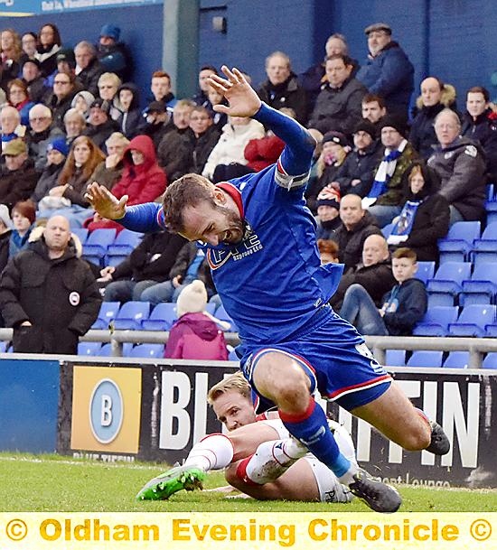 OUCH . . . skipper Liam Kelly goes to ground under a strong challenge.