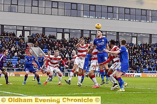 striker Jake Cassidy gets up best to win a header.