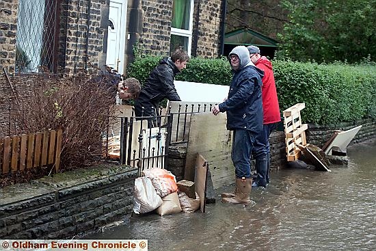 FLOOD defence . . . residents in Delph New Road, Delph