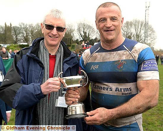 TOP MAN . . . Matt Calland receives the Ben Powell Trophy from Rugby Oldham’s Mike Kivlin. 