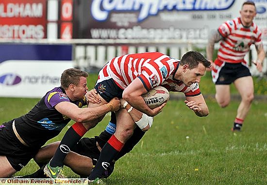 HEADING FOR THE GRASS: Forward Adam Neal is hauled down by Newcastle tacklers.