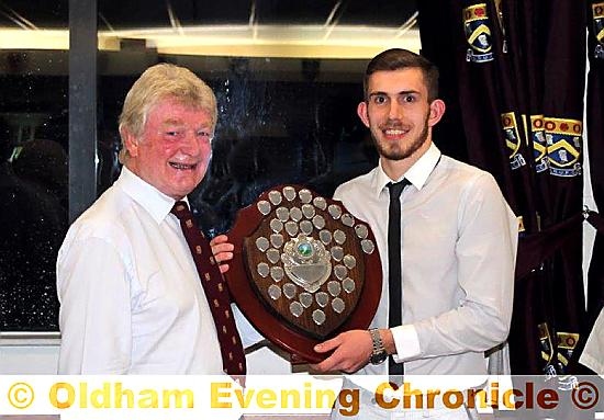 HONOUR: Ryan North picks up the players’ player award from Oldham RUFC president Brian Smith.