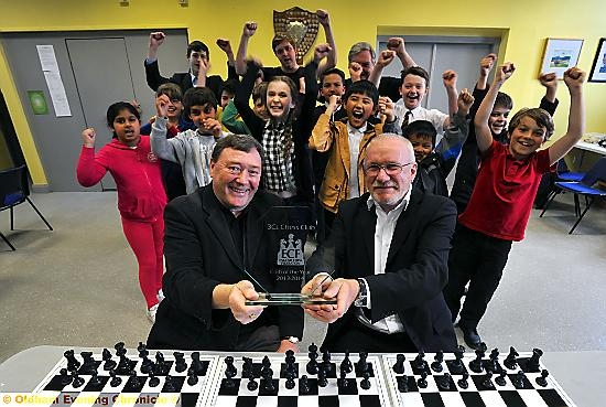 WINNERS: 3Cs Chess Club chairman Steve Rigby (left) receives the award from Julian Clissold of the English Chess Federation Board