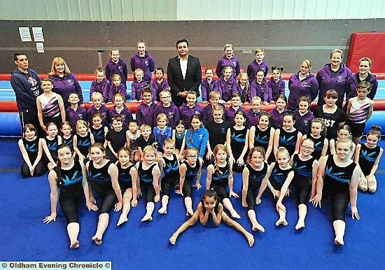 Cllr Kaiser Rehman (back, centre) donates £2,000 to Eclipse Gymnastics Club, Hathershaw.