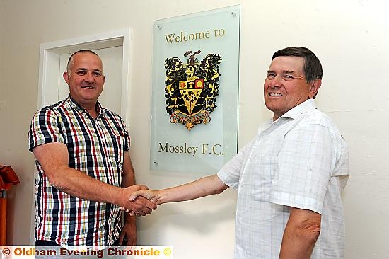 HAPPIER TIMES: former Borough chairman Mark Kilgannon (left) is welcomed to Mossley’s Seel Park by Lilywhites director Steve Tague last summer.