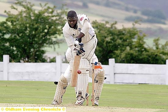 STRAIGHT BAT: Alton Beckford defends on the way to a fine knock of 116 for Micklehurst against Saddleworth.