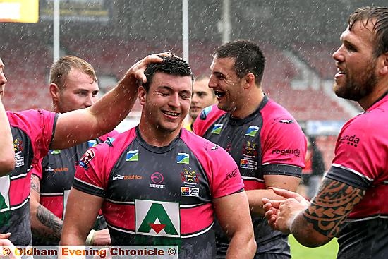 ALL SMILES: Liam Thompson (centre) celebrates.