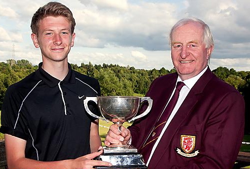 IT’S MINE . . . Matthew Kay receives the District Championship trophy from Brookdale captain Phil Forshaw.