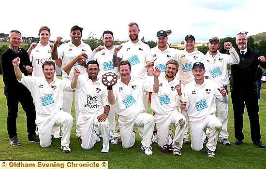 WHAT A FEELING: Saddleworth’s players celebrate alongside joint team manager Peter Gill (left) and scorer Paul Seddon. 