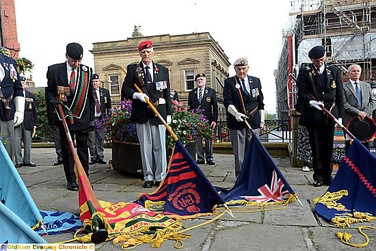 STANDARDS are lowered in tribute to those who died