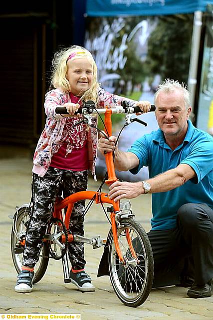 ON HER BIKE: Darcie Marsland (6) with Wayne O'Connor, cycle officer for TfGM.