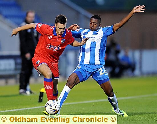 GO FOR IT . . . Athletic striker Rhys Turner tries to make progress.