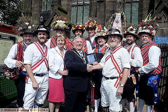 WELCOME to Saddleworth . . . parish council chairman Neil Allsopp meets Bill Singleton from the Adelaide Morris Men.