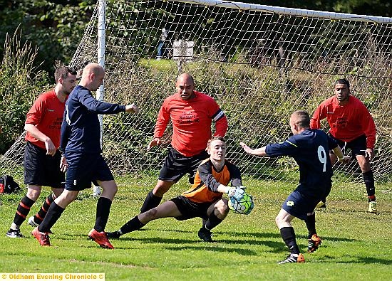 BRAVE STOP . . . Crown goalkeeper Mark Pellowe saves in a crowded goalmouth.