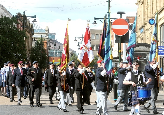 ON the march . . . the memorial parade makes its way through Oldham town centre
