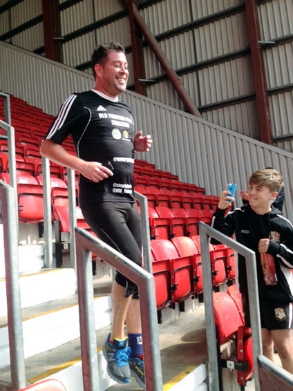 STEPPING it up for charity . . . Liam O’Reilly climbs up and down every step in the ground