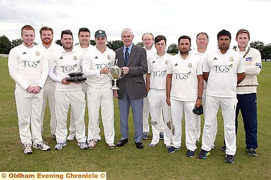 TITLE TRIUMPH: Saddleworth captain Brian Lord receives the Hollingworth Challenge Trophy from Eddie Bayliss, chairman of the SWB Commercials Saddleworth and District Cricket League. 