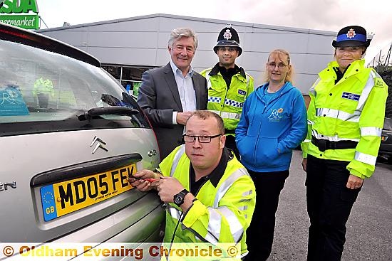 Pictured at the number plate crime prevention day are (back, from the left) Police and Crime Commissioner Tony Lloyd, PC Kristian Kurmul, car owner Tracy Eccles and PCSO Joanna Haigh. Front is AA mechanic Chris Handley