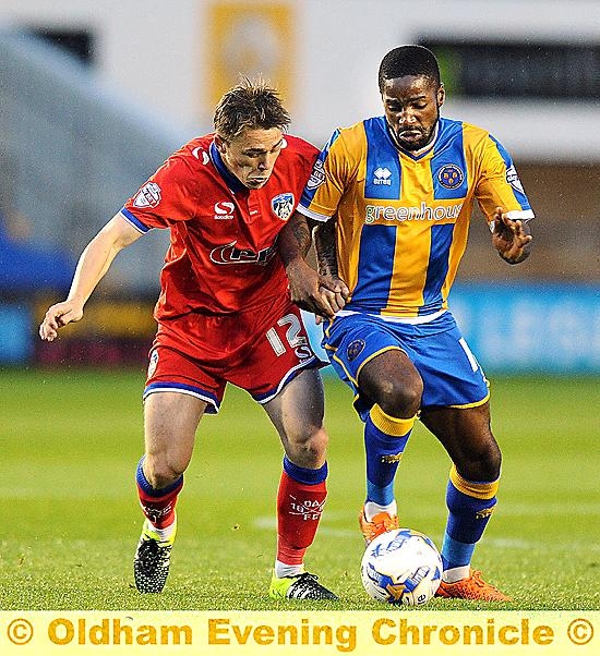 LOCKED TOGETHER . . . George Green attempts to wrestle possession from a Shrewsbury rival.