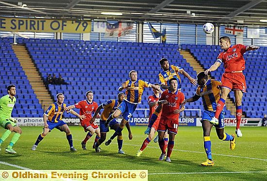 HIGH FLIER . . . James Wilson leaps at the far post to get in a header.